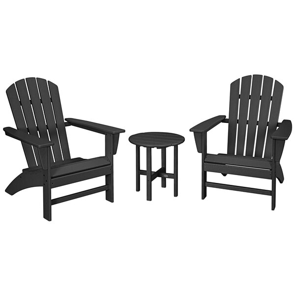 A group of three black POLYWOOD Nautical Adirondack chairs and a round table on an outdoor patio.
