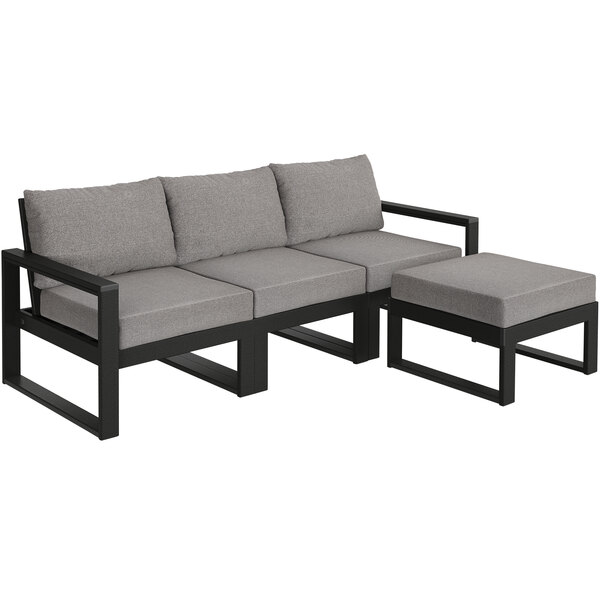 A black and grey POLYWOOD outdoor sectional couch with a grey cushion and ottoman.