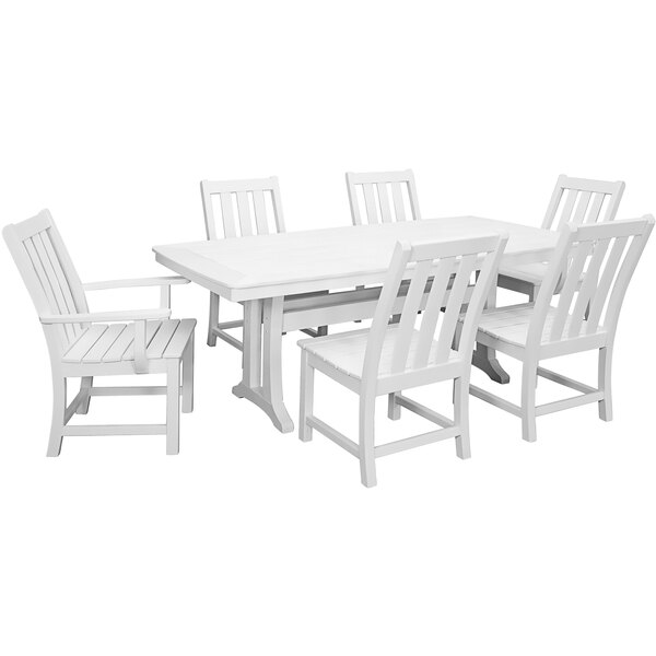A white POLYWOOD dining table with white chairs.