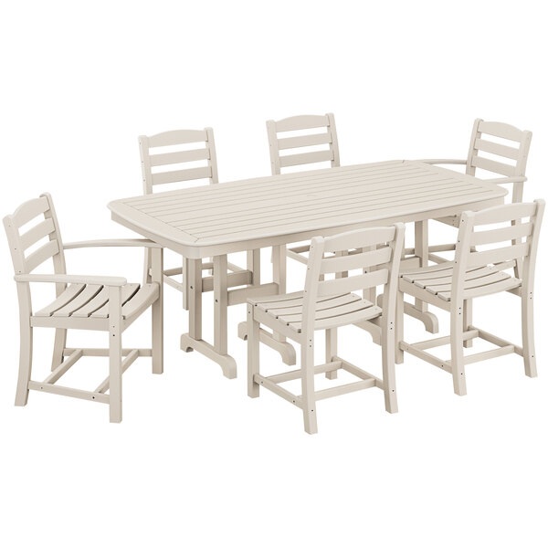 A POLYWOOD white La Casa Cafe dining set with a Nautical table and six chairs on an outdoor patio.