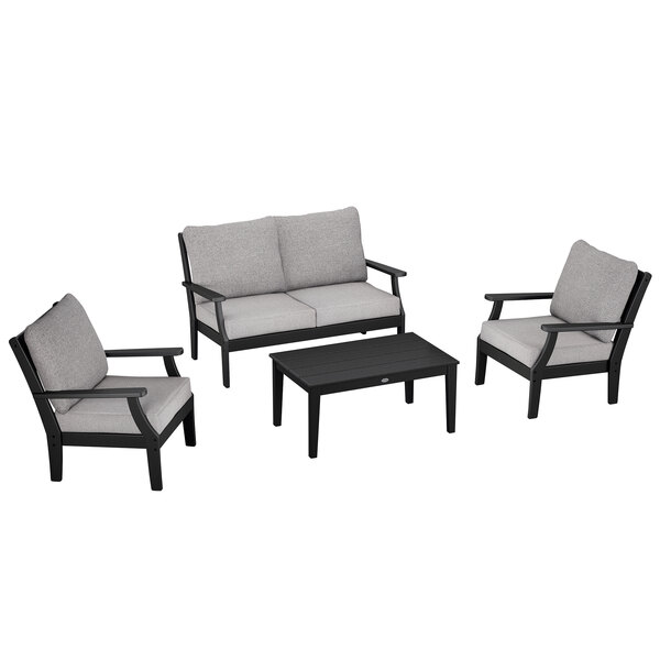 A black and grey POLYWOOD outdoor patio set with chairs, a settee, and a table.