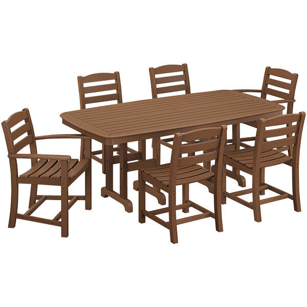 A POLYWOOD teak dining table with six chairs on a patio.