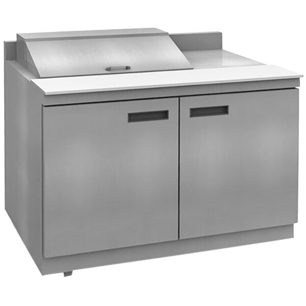 A stainless steel counter with a white top and four drawers.