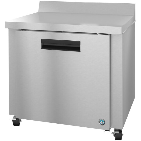 A stainless steel Hoshizaki worktop refrigerator with a black handle on wheels.