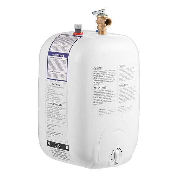 A compact, white electric water heater with labeled instructions and warning stickers, featuring two pipe connections and a control knob on the front.