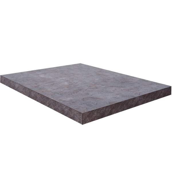 A rectangular BFM Seating Relic table top in a gray stone finish.