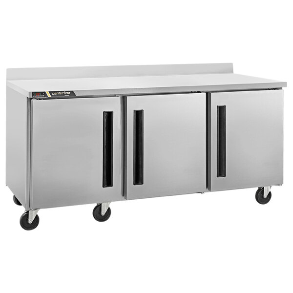 A Traulsen Centerline stainless steel worktop refrigerator with three left hinged doors.