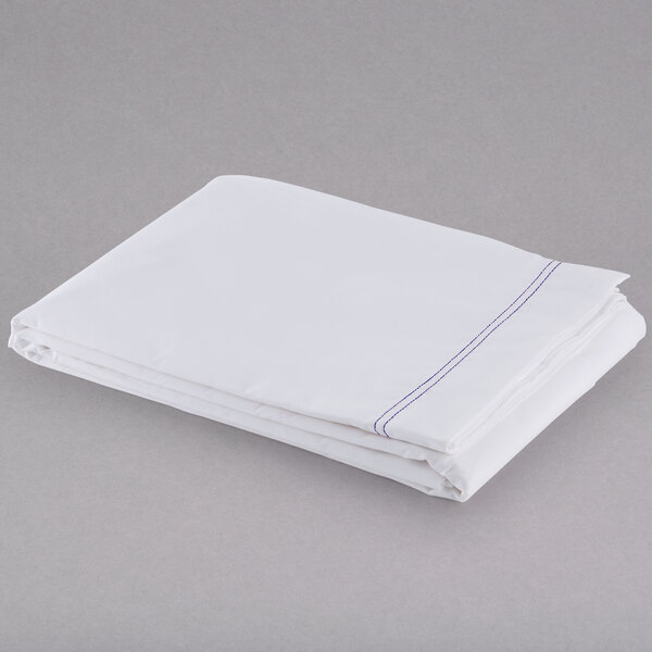 A folded white Oxford Superblend full size flat sheet on a gray surface.