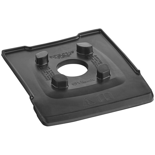A black plastic centering pad with a hole in the middle.