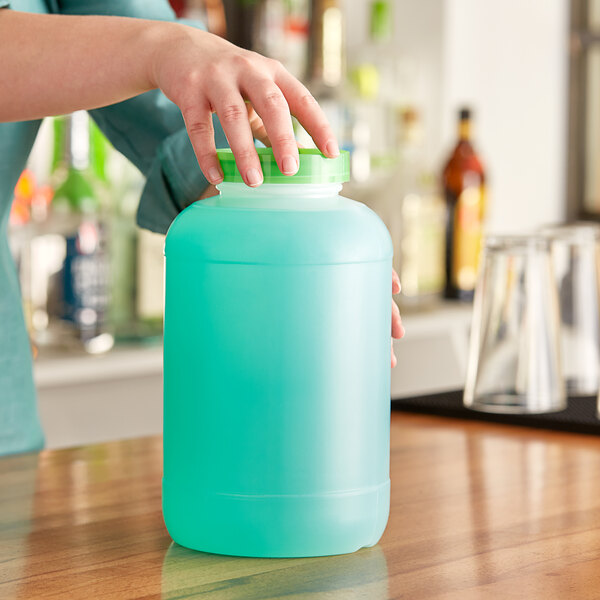 A woman pouring liquid into a green Choice container.