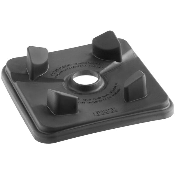 A black square Vitamix centering pad with four holes.