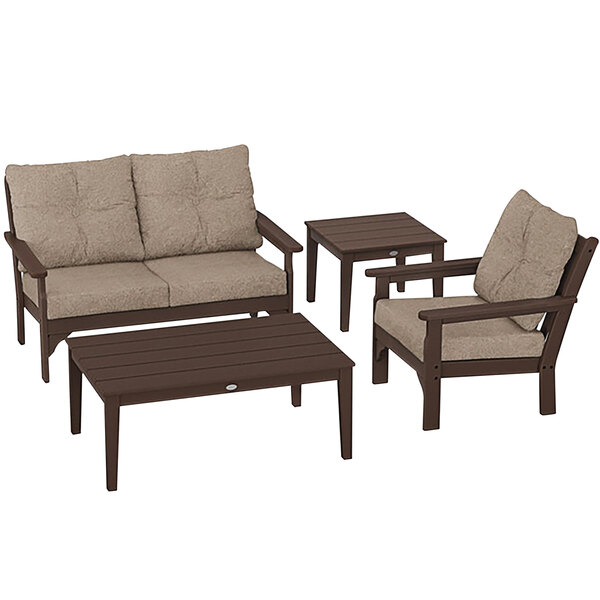 A POLYWOOD outdoor patio set with a table, chair, and beige cushions.