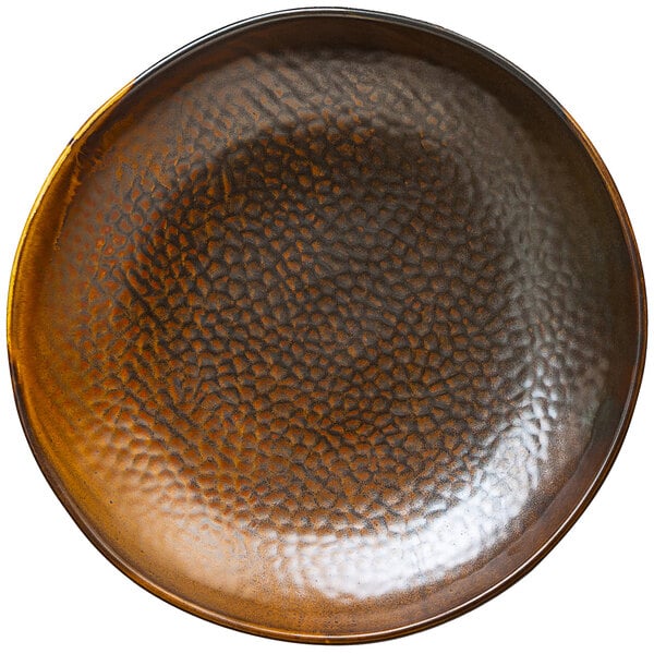 A brown porcelain plate with a textured surface and a black rim.