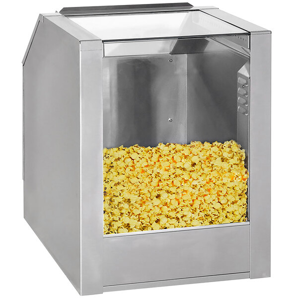A Cretors silver metal counter showcase warming cabinet with popcorn inside.