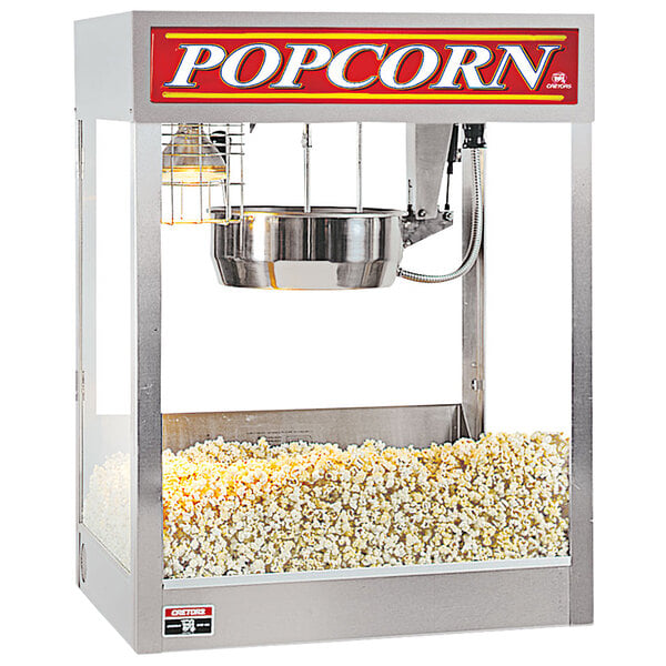 A Cretors popcorn popper machine with popcorn in it on a silver metal stand.