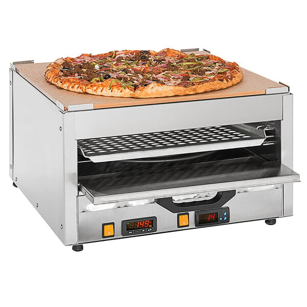 A Cretors countertop pizza oven with a pizza on top.