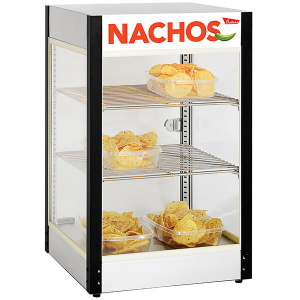 A Cretors nacho display cabinet filled with chips in a plastic container.