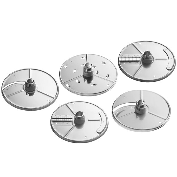 A set of silver circular food processor discs with holes and a metal nut.