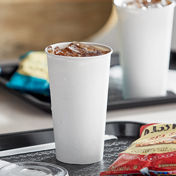 A tray with a white Choice paper cold cup filled with ice on a black surface.