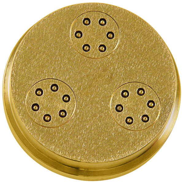 A gold circular object with four holes.