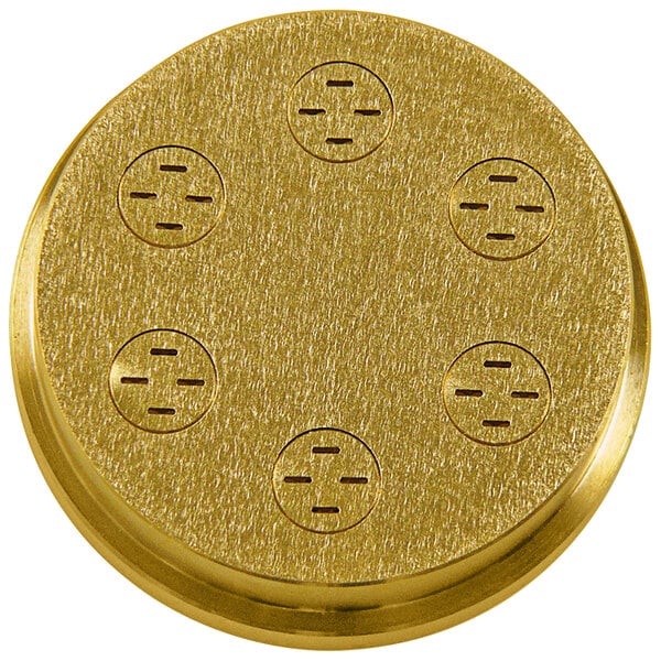 A gold circular pasta die with holes.