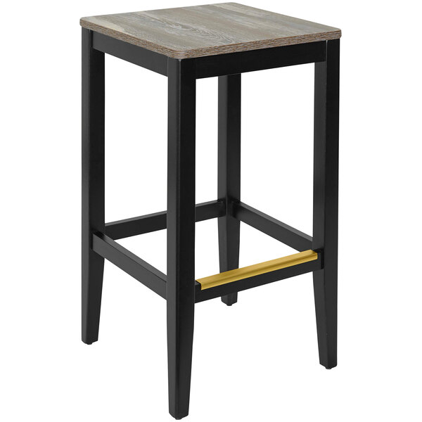 A black beechwood barstool with a wooden seat and black legs.