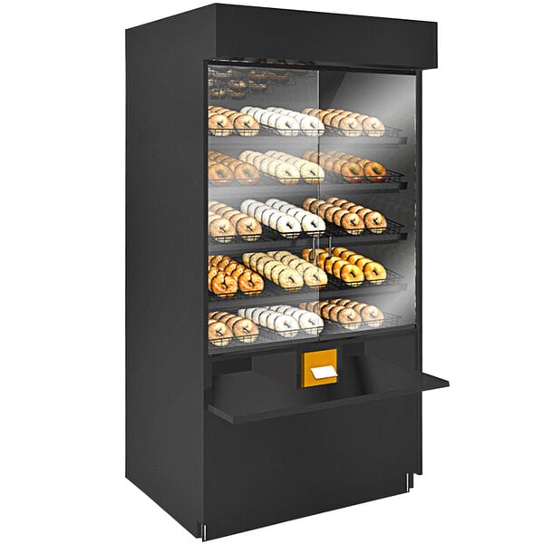A Structural Concepts non-refrigerated pastry case with donuts on shelves.
