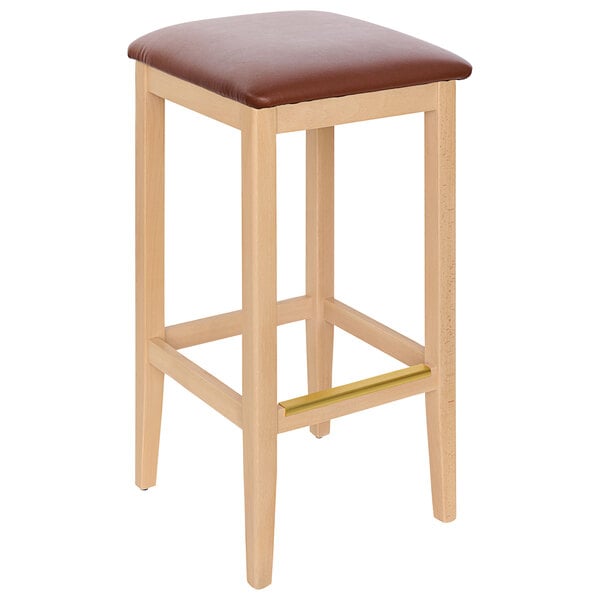 A BFM Seating Stockton natural beechwood backless barstool with a light brown vinyl seat.