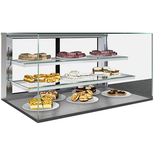 A Structural Concepts countertop bakery display case with two shelves holding various cakes.
