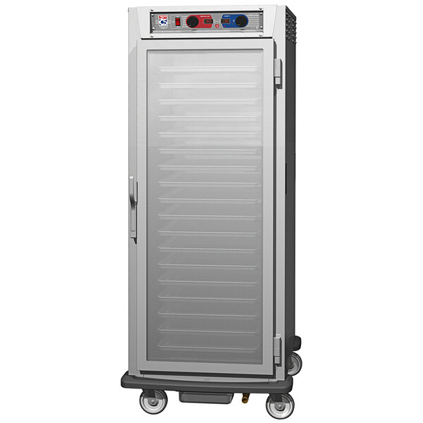 A stainless steel Metro C5 holding cabinet with clear door on wheels.
