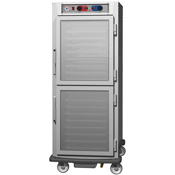 A stainless steel Metro C5 holding cabinet with clear Dutch doors on wheels.