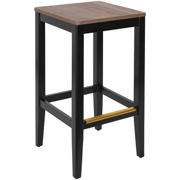 A black beechwood backless barstool with a wooden seat.