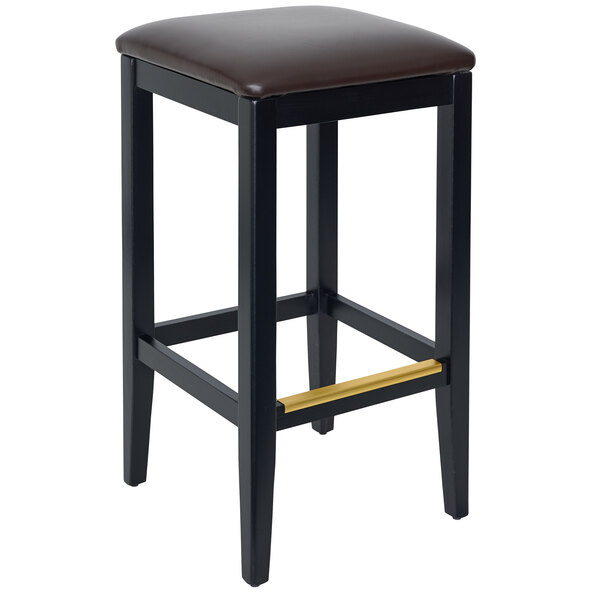 A black BFM Seating barstool with a dark brown cushion on a table in a bar.
