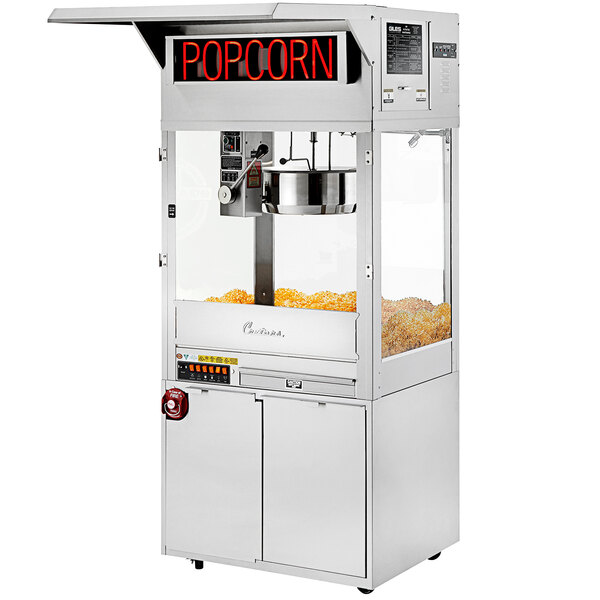A Cretors floor model popcorn machine with a bucket of popcorn inside.