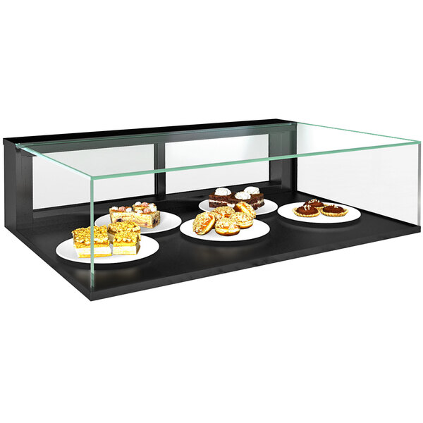 A Structural Concepts countertop bakery display case with plates of food.