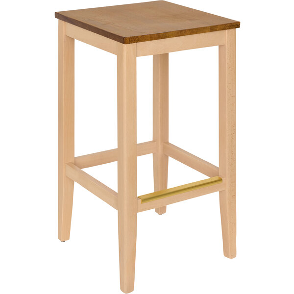 A BFM Seating Stockton natural beechwood backless barstool with a wooden seat.