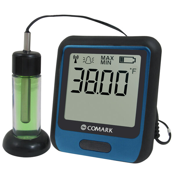 A Comark digital temperature data logger with a glycol buffer probe on a counter.