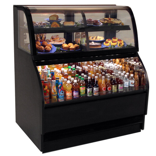 A Structural Concepts Harmony refrigerated dual service merchandiser case on a bakery counter with food and drinks inside.