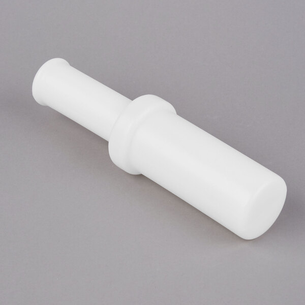 A white plastic tube with a small hole on a gray background.