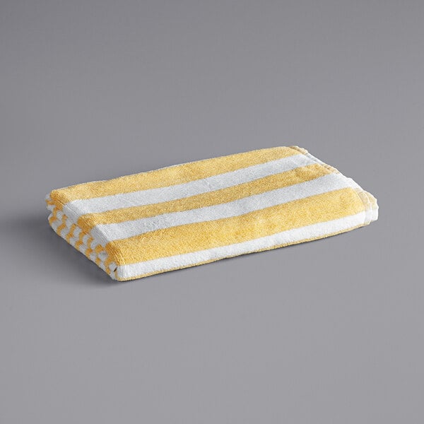 A yellow and white striped Oxford Cabana pool towel.