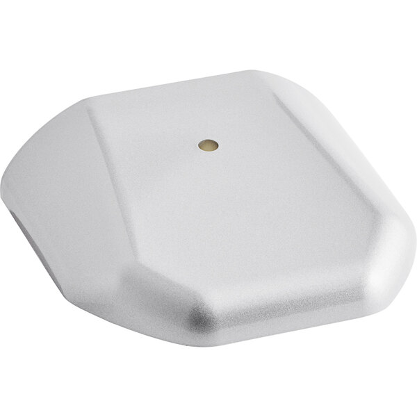 A white plastic top cover with a square shape and a dot in the middle.