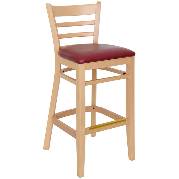 A BFM Seating Berkeley wooden bar stool with a burgundy vinyl seat.