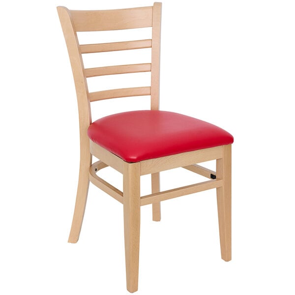 A BFM Seating wooden restaurant chair with a red vinyl cushion.