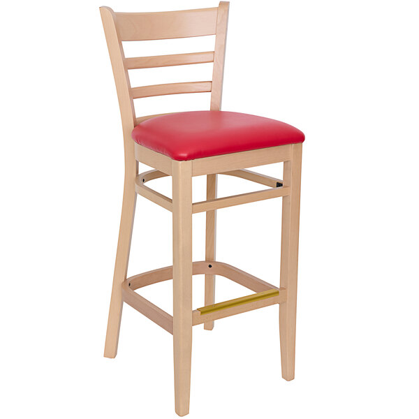 A BFM Seating Berkeley wooden ladder back barstool with a red vinyl seat.
