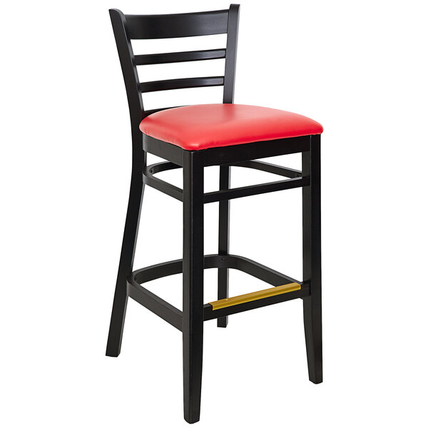 A BFM Seating black beechwood barstool with a red vinyl seat.