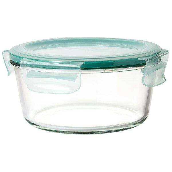 An OXO clear glass container with a green lid.