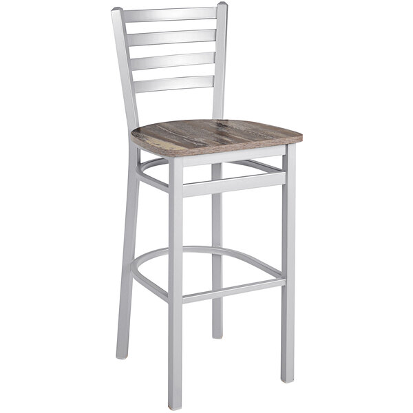 A BFM Seating silver mist steel ladder back bar stool with a wood and white seat.