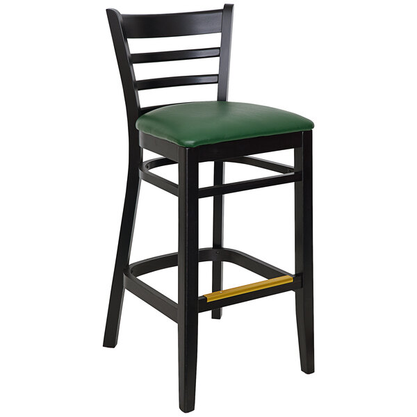 A BFM Seating black beechwood barstool with a ladder back and green vinyl seat.