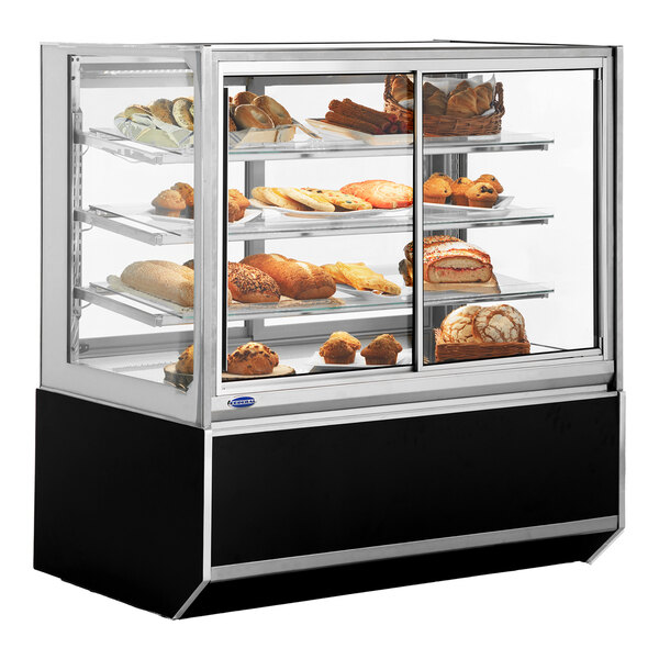 A Federal Industries Italian Series bakery display case with baked goods on shelves.