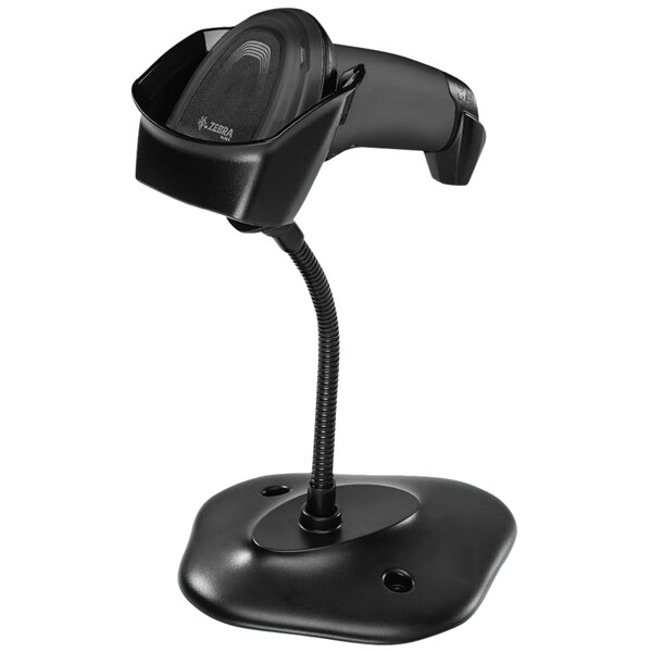 A black barcode scanner on a stand.